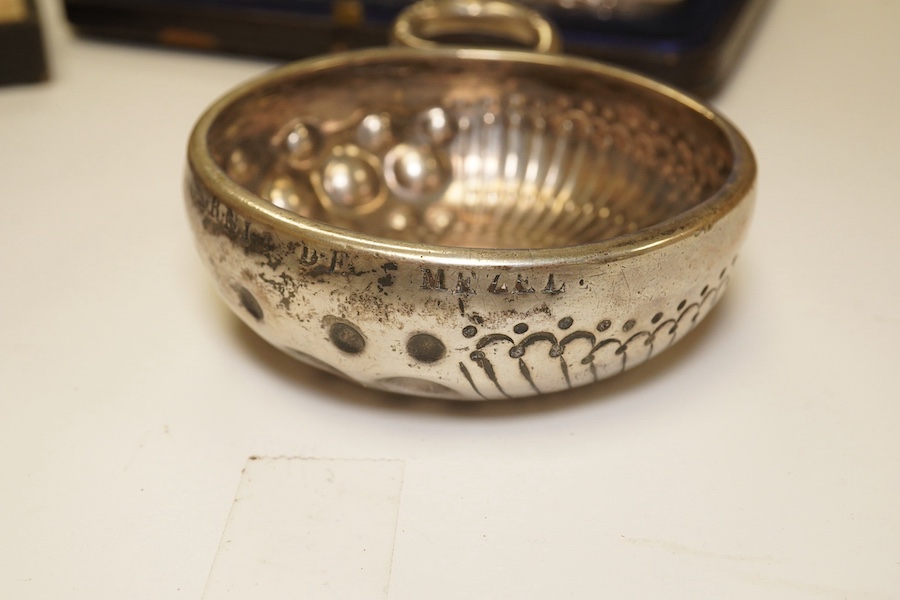 A French 800 standard white metal taste vin, 11cm, together with a George III silver toddy ladle, London, 1799, a cased set of six Art Nouveau silver coffee spoons by William Hutton & Sons and two incomplete cased silver